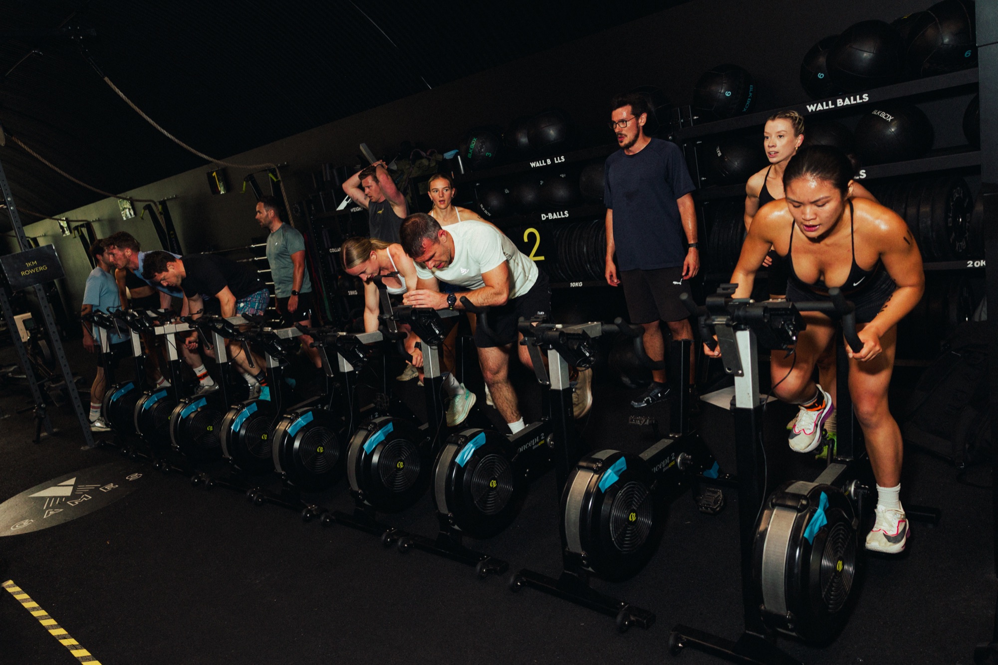 Athletes racing on bike ergs at a Team Aretas competition